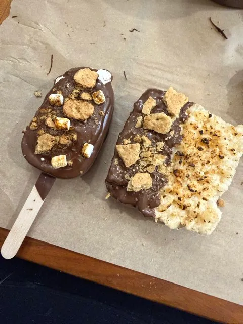 S'mores cakesicle next to a dipped Rice Krispies square